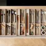 Organized kitchen pull-out drawer with wooden inserts and cutlery