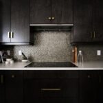 Dark navy blue kitchen cabinets with ceramic stovetop