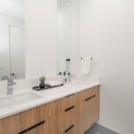 Modern single bathroom vanity with white cabinet and mirror